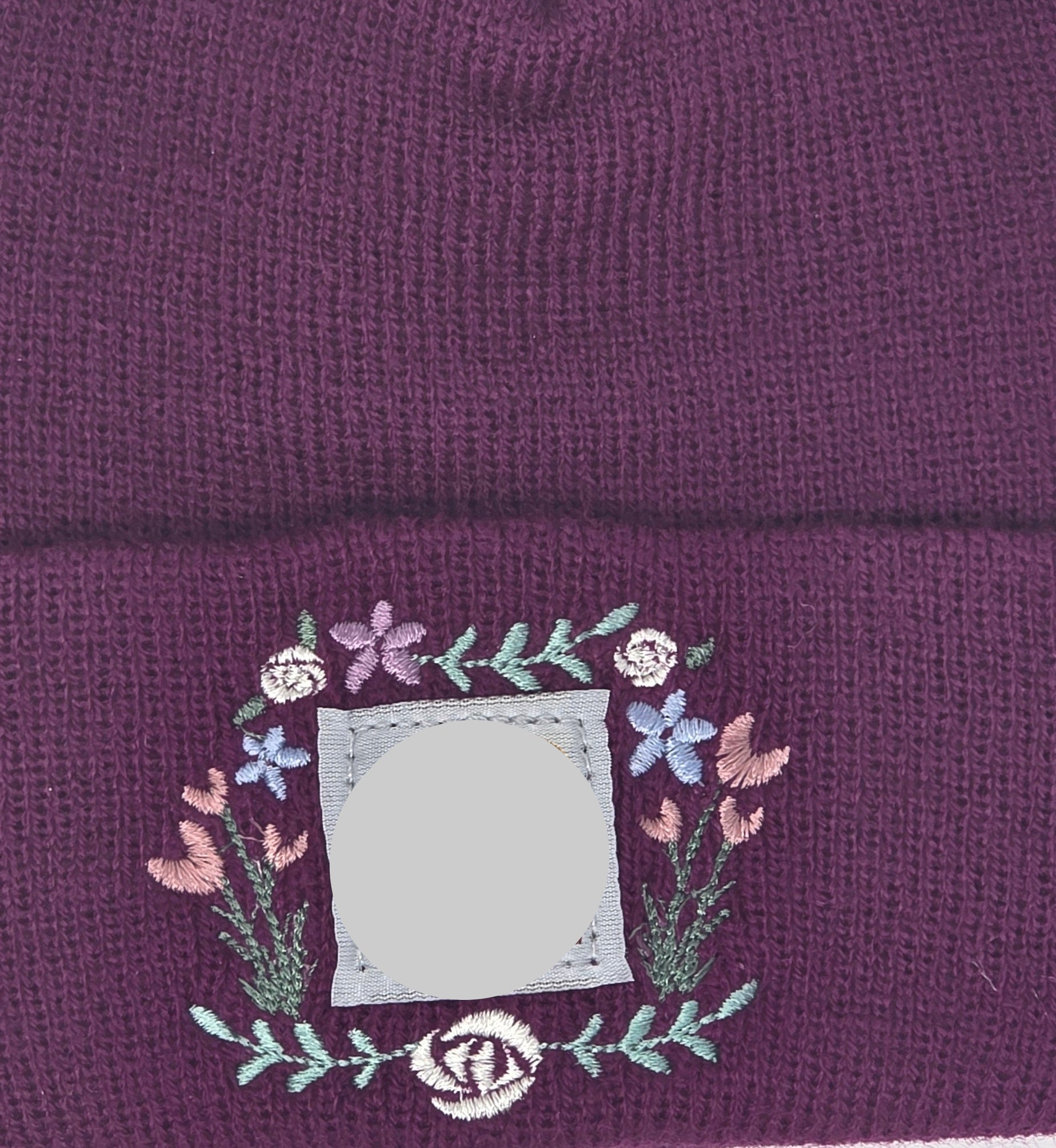 Purple beanie with floral design.
