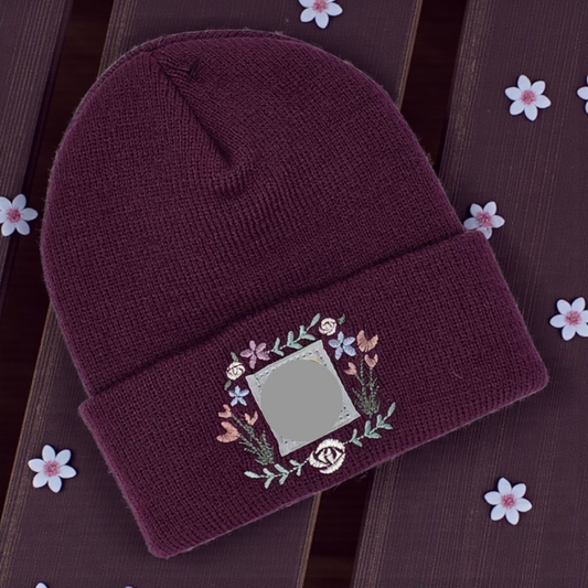 Maroon beanie with floral design on a floral-patterned background