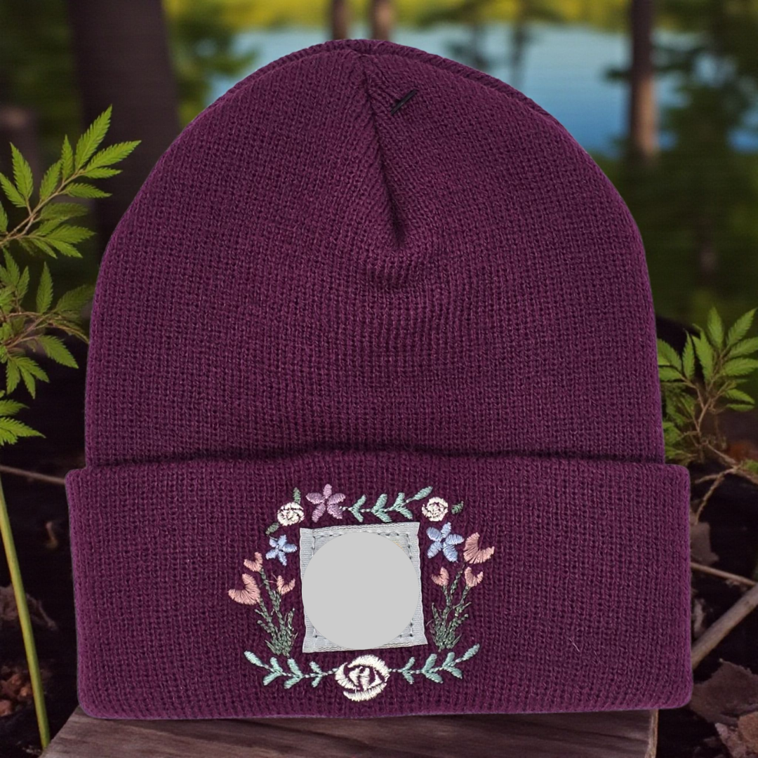 Purple beanie with floral design against a natural background