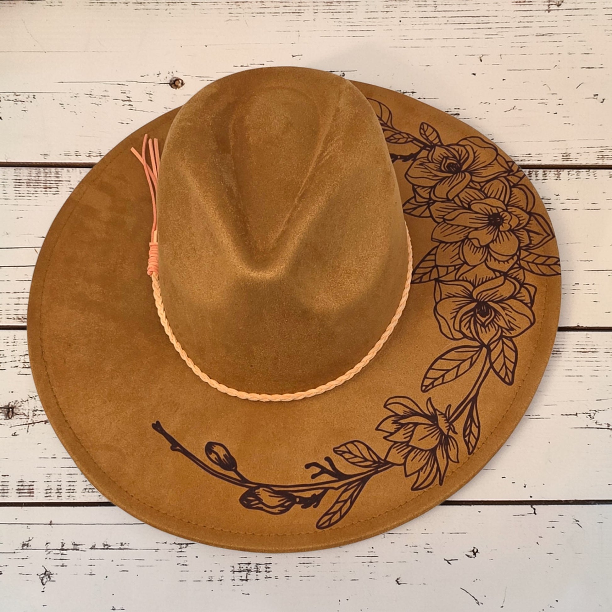 Elkhorn Designs chestnut vegan suede wide-brim hat with laser-engraved gardenia floral design and braided tassel band