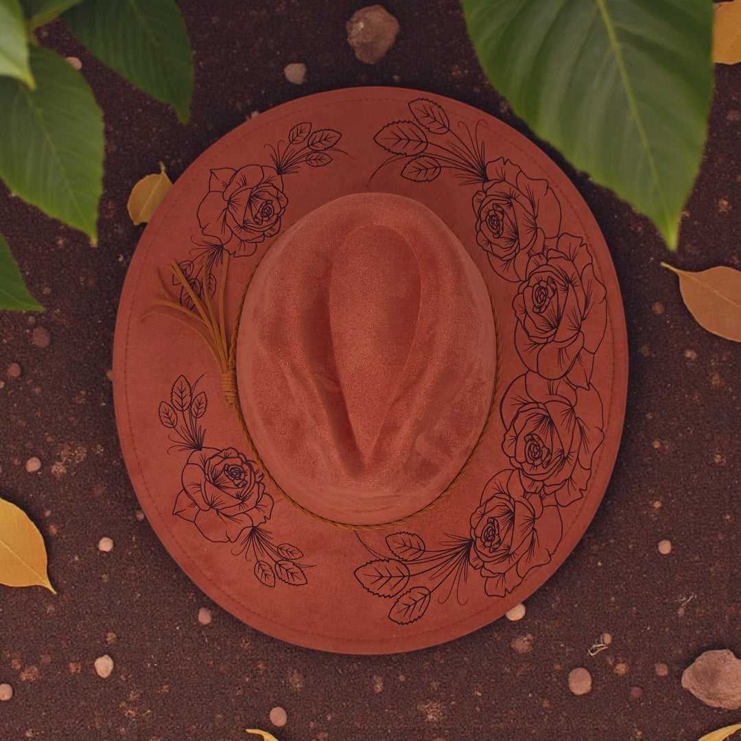 Elkhorn Designs vegan suede wide brim hat in rose with intricate laser-engraved floral patterns on the brim